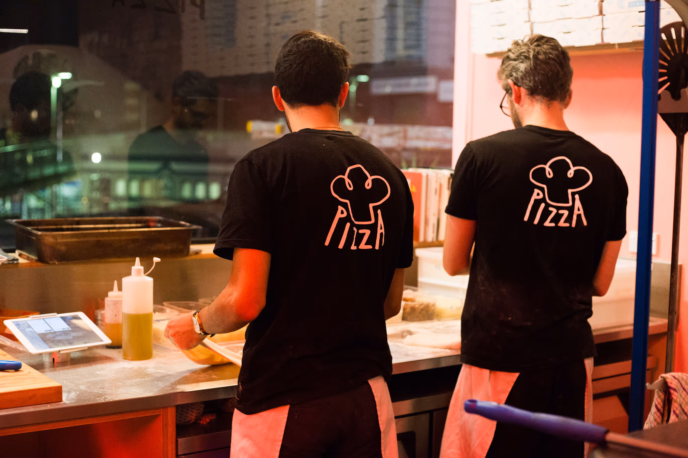 Umu Pizza kitchen staff in branded uniforms, designed by Blink, Auckland