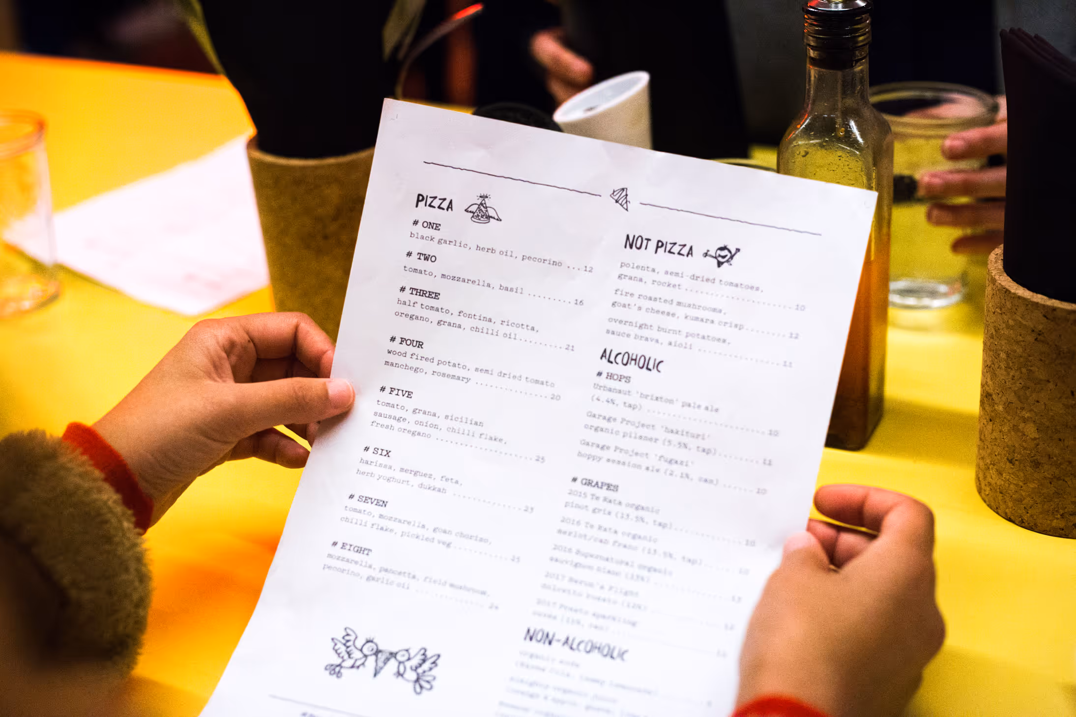 Umu Pizza branded menu with hand-drawn illustrations, designed by Blink, Auckland