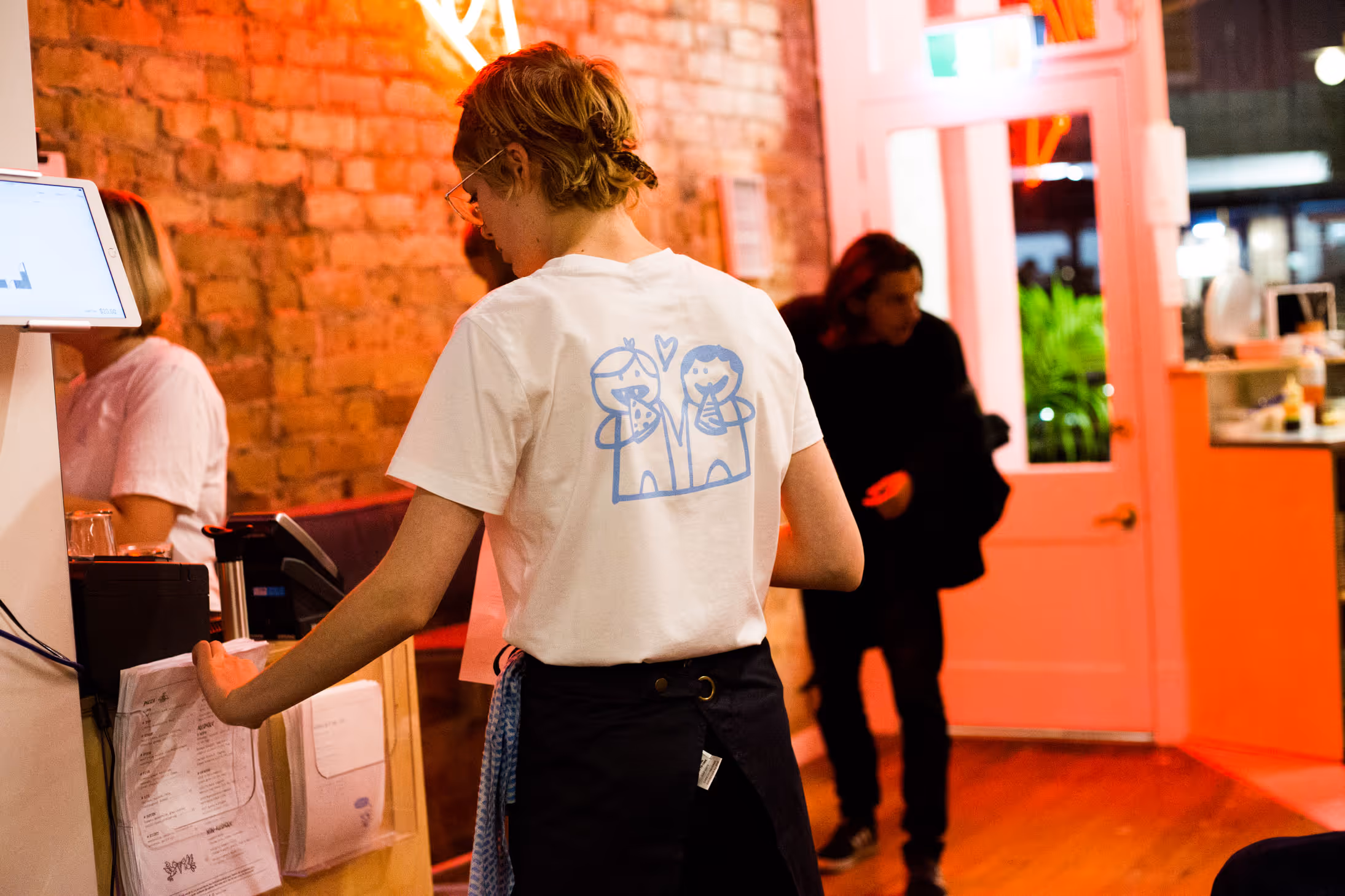 Umu Pizza staff uniform with hand-drawn character illustration, designed by Blink, Auckland