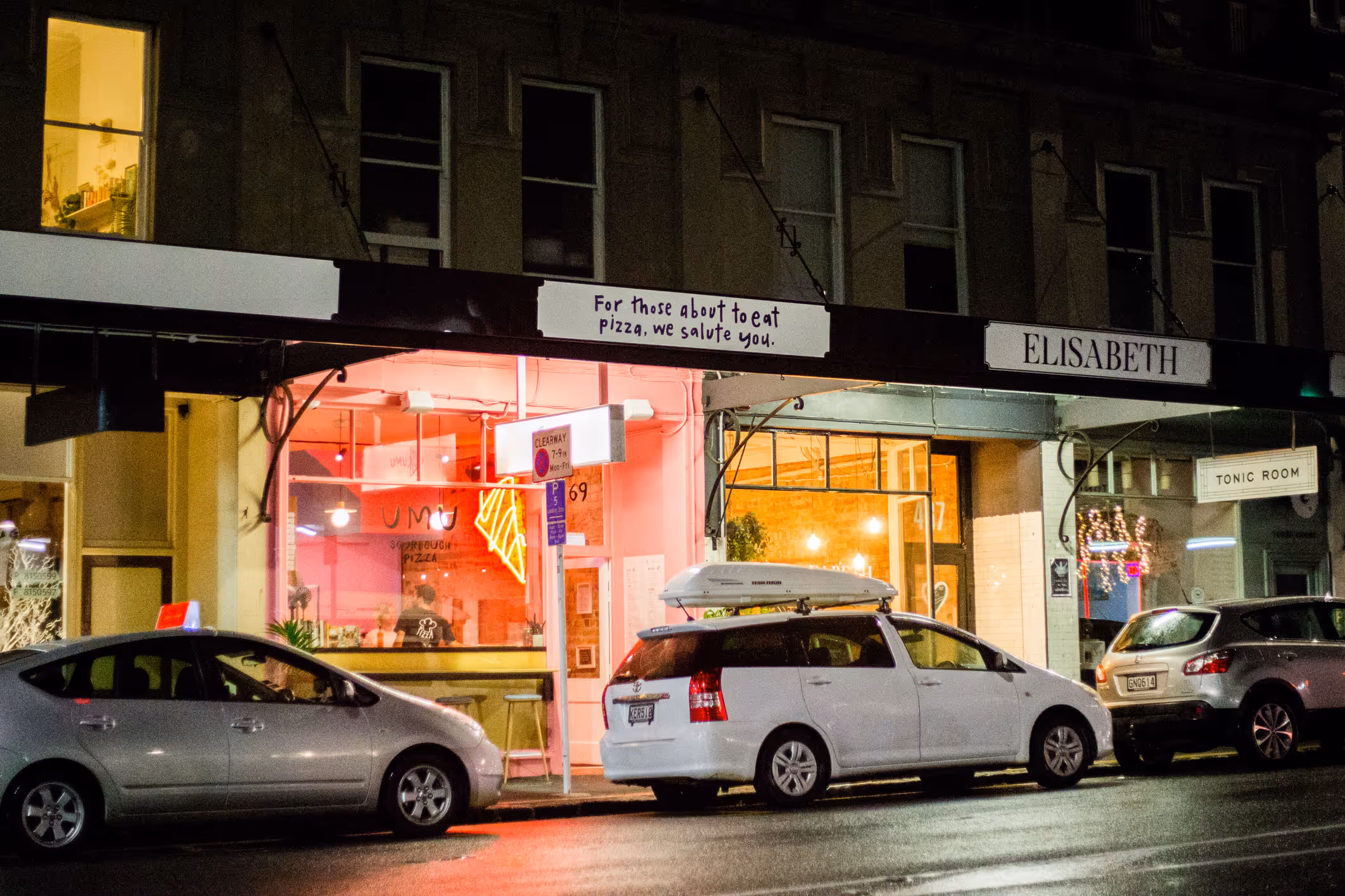 Umu Pizza pink shopfront and signage in Kingsland at night, designed, fabricated and installed by Blink, Auckland