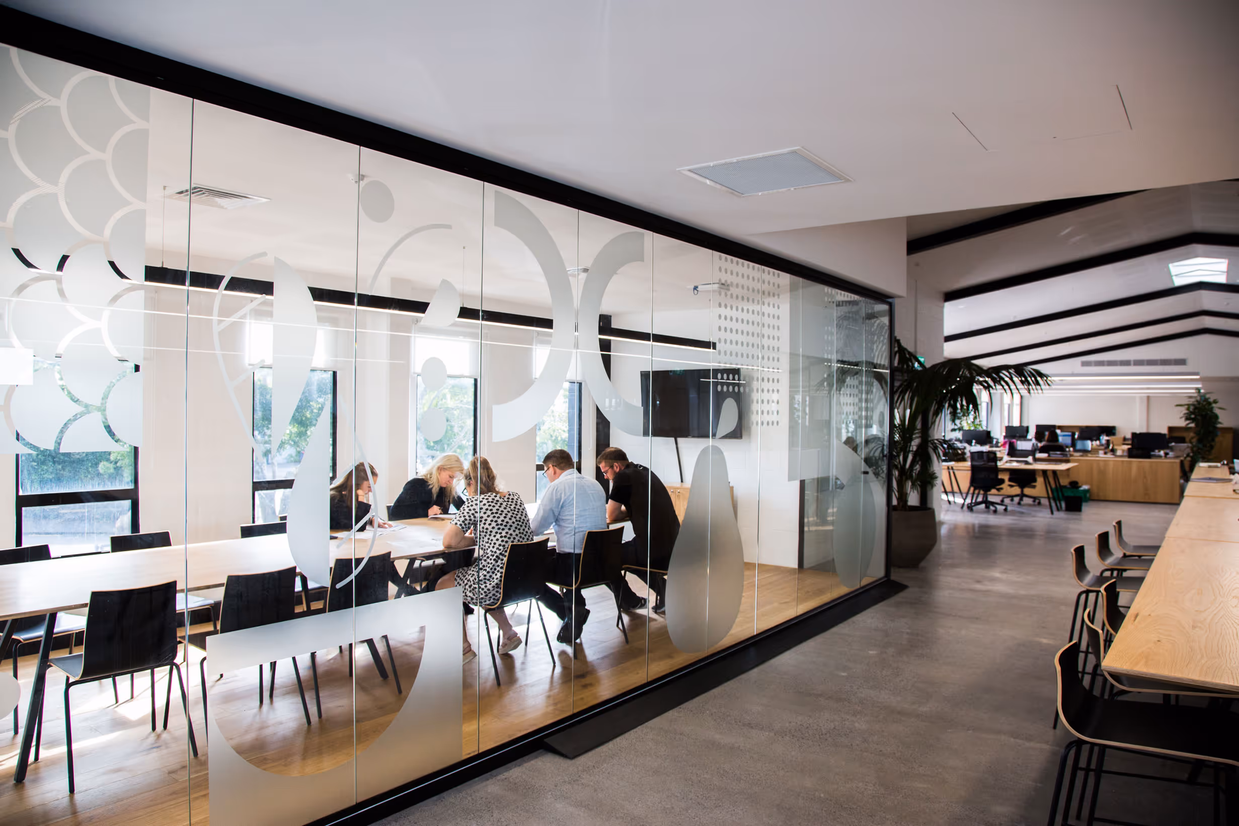 Custom frosted glass decals with abstract iconography on meeting room windows for Collective office by Blink