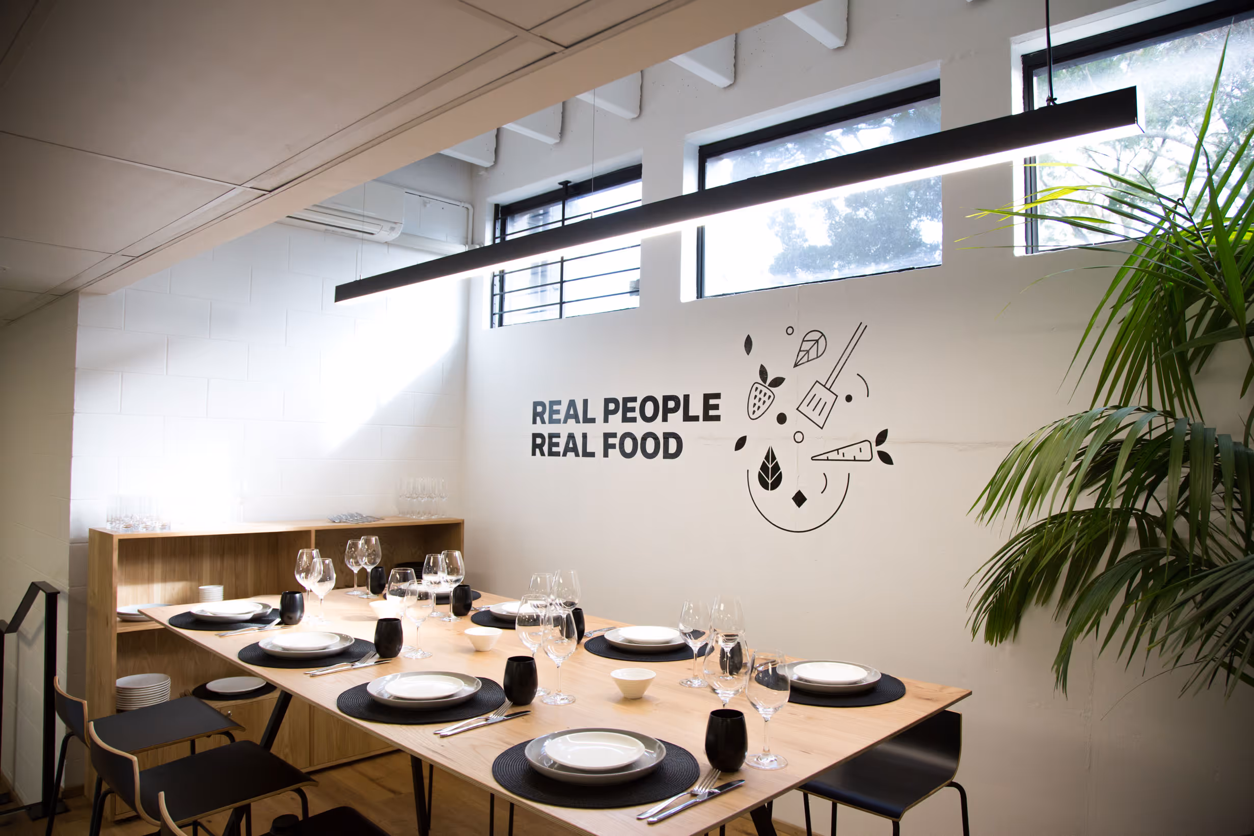Custom 'Real People Real Food' typographic wall decal and abstract food iconography in Collective tasting room by Blink