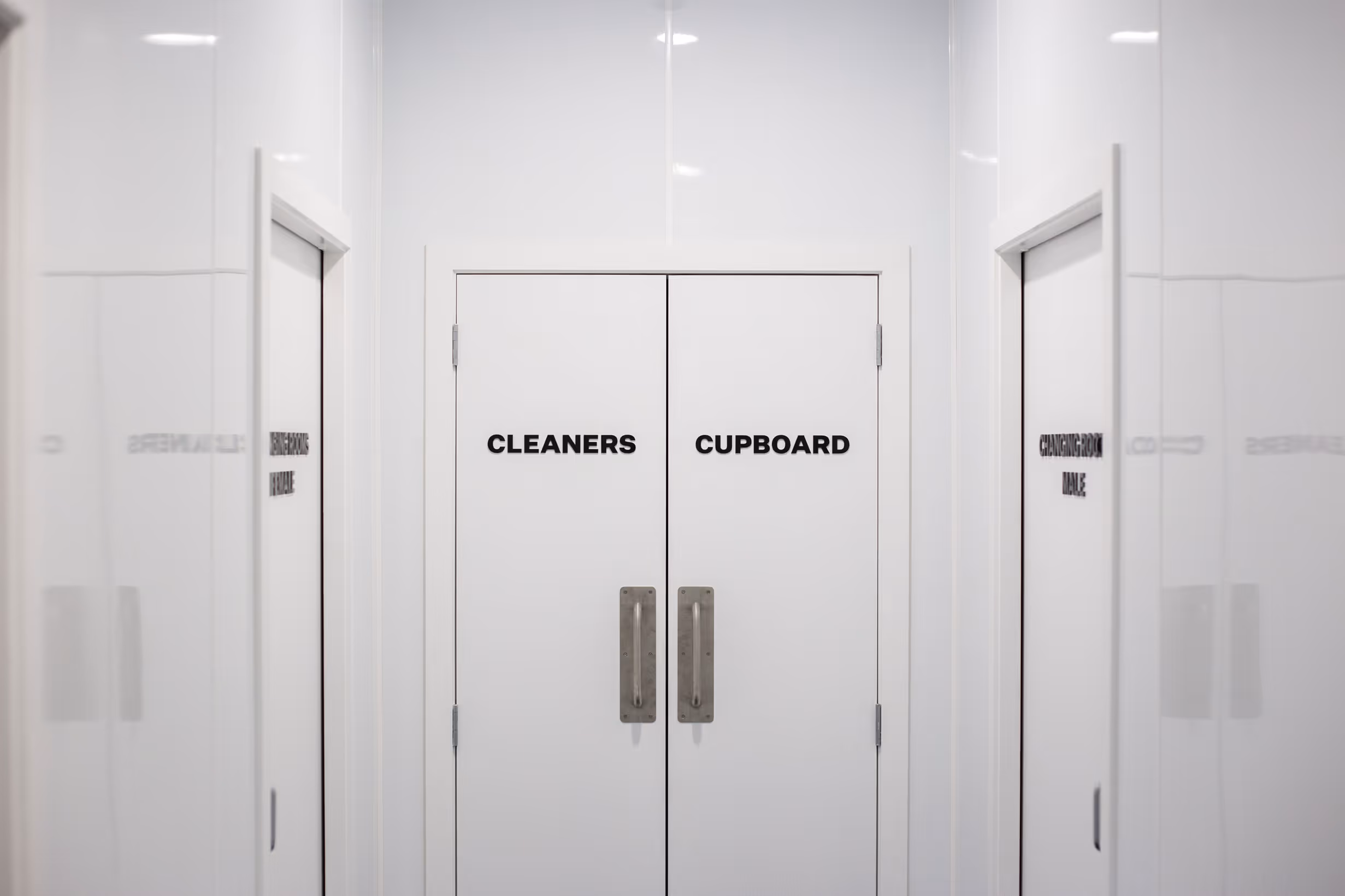 Minimalist black typographic wayfinding door decals for Collective workspace by Blink