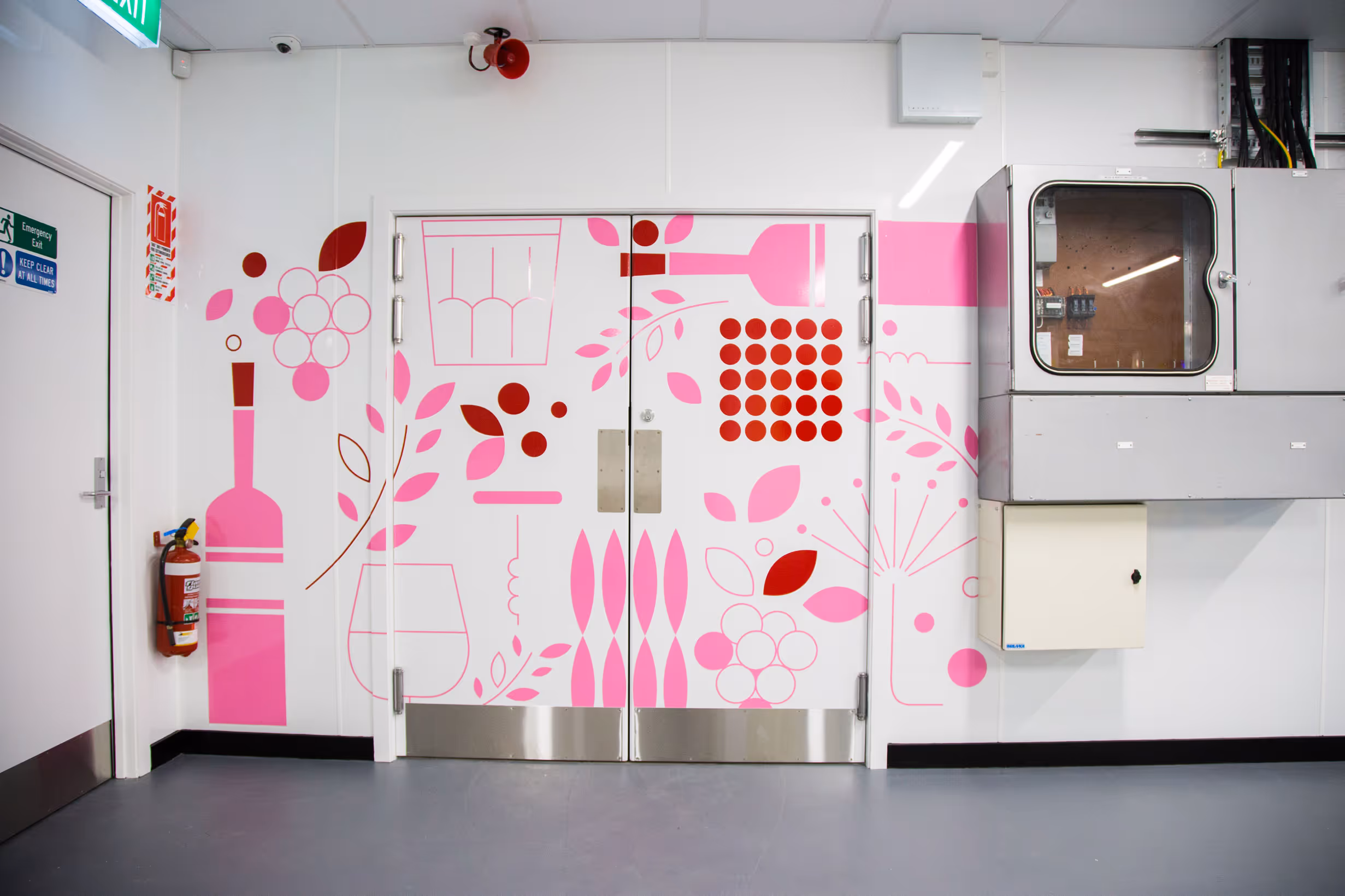 Custom vibrant pink and red wall and door decals featuring abstract wine and food iconography for Collective workspace