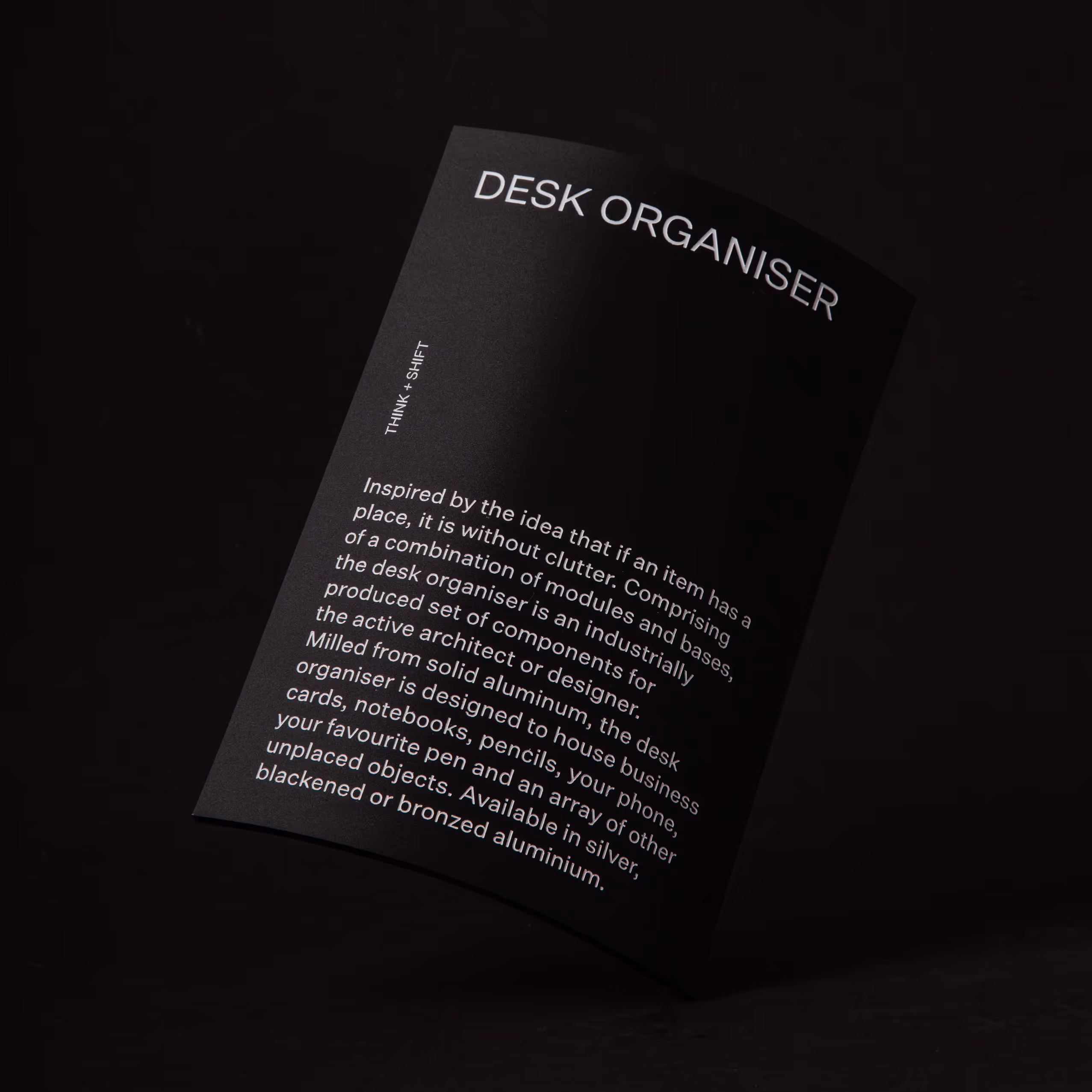 A black product description card with white text detailing a desk organiser by Blink