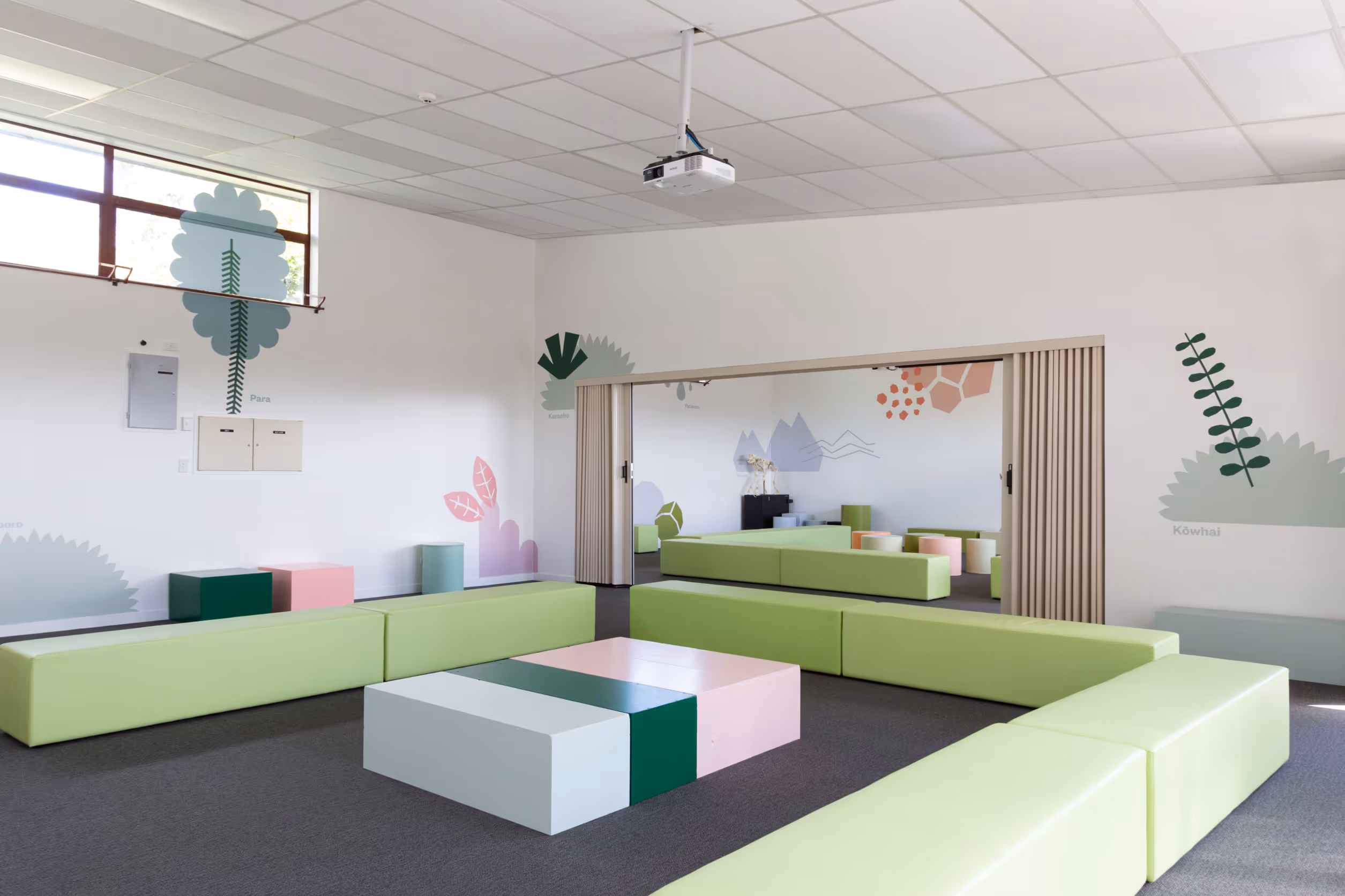 School room at Auckland Zoo, featuring wall murals of native New Zealand plants by Blink and geometric modular seating