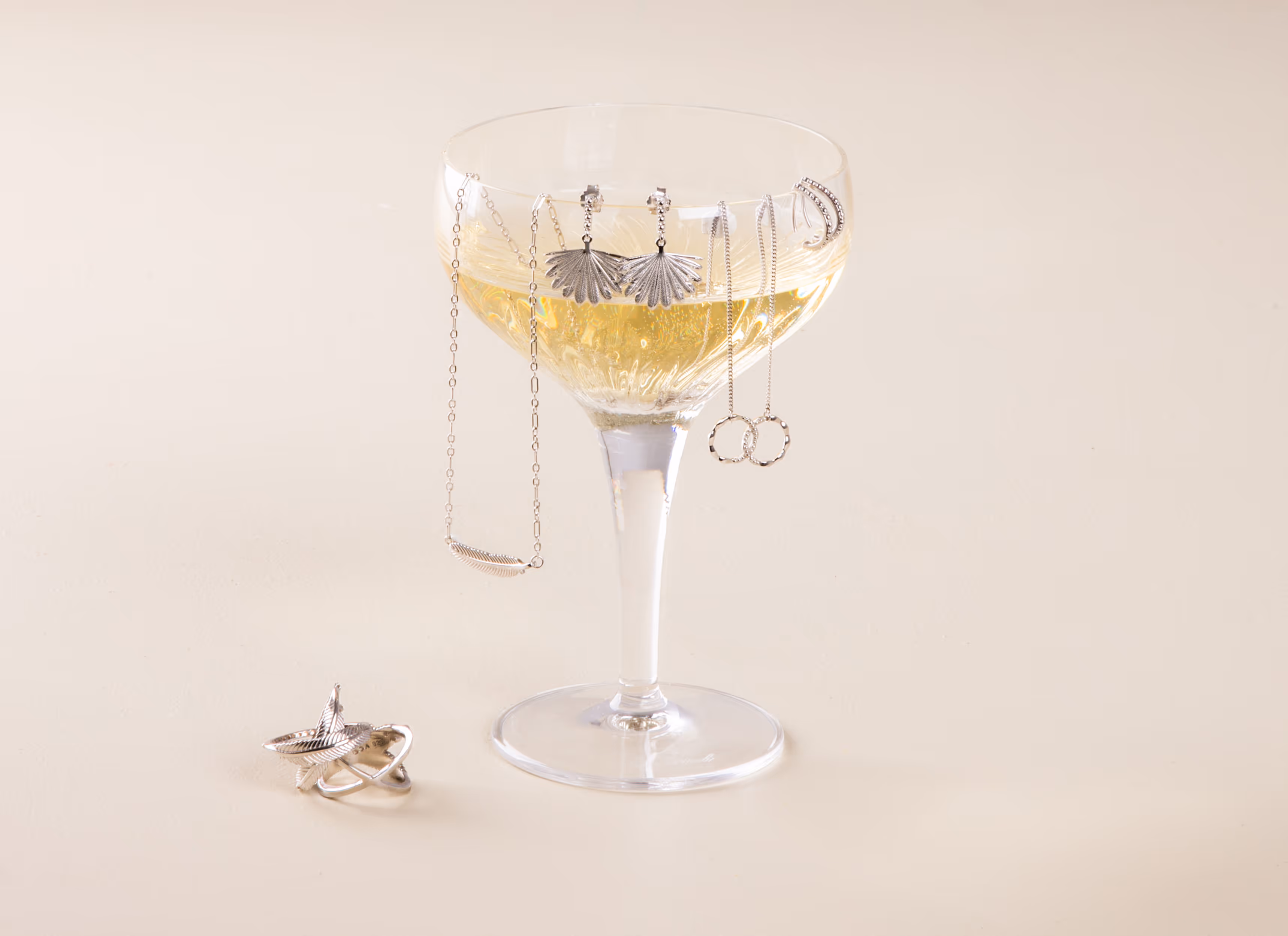 Boh Runga Jewellery collection styled on champagne coupe glass, photography by Blink, Auckland