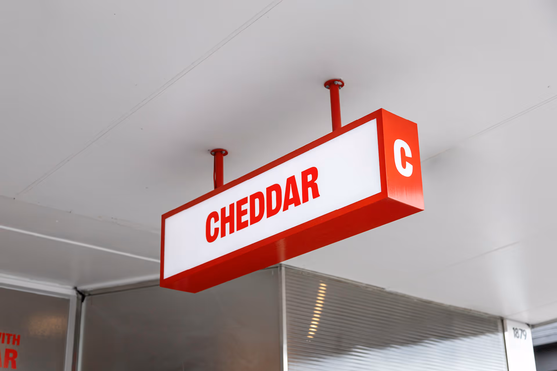 Cheddar Avondale suspended illuminated lightbox sign, designed, fabricated and installed by Blink, Auckland