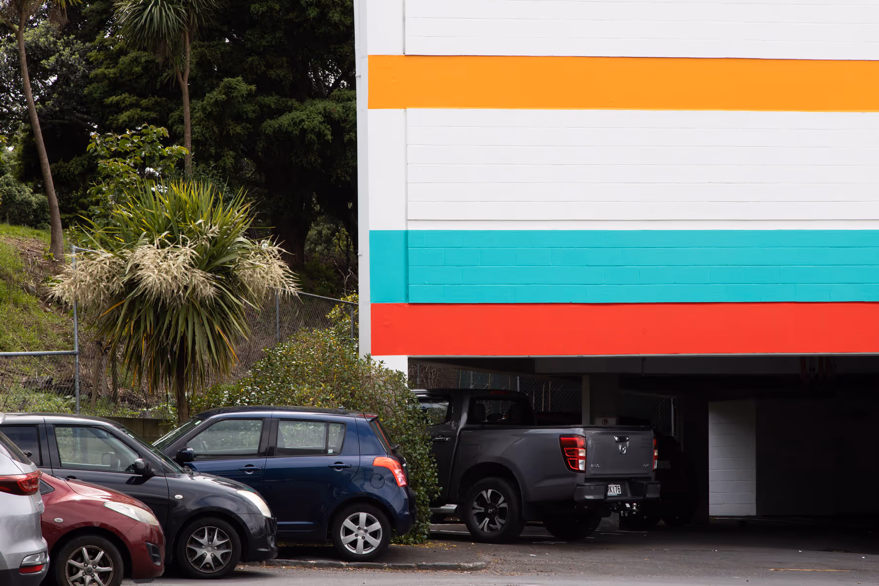 Exterior wall detail of painted horizontal stripe supergraphics for Burnett Foundation Aotearoa, painted by Blink, Auckland