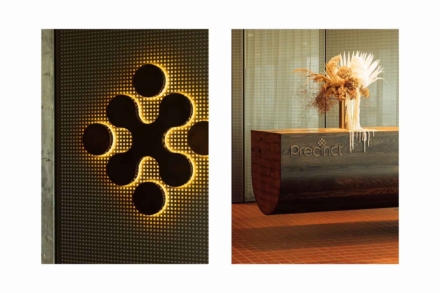 Illuminated wall signage and a wooden reception desk with dried floral arrangement for Precinct