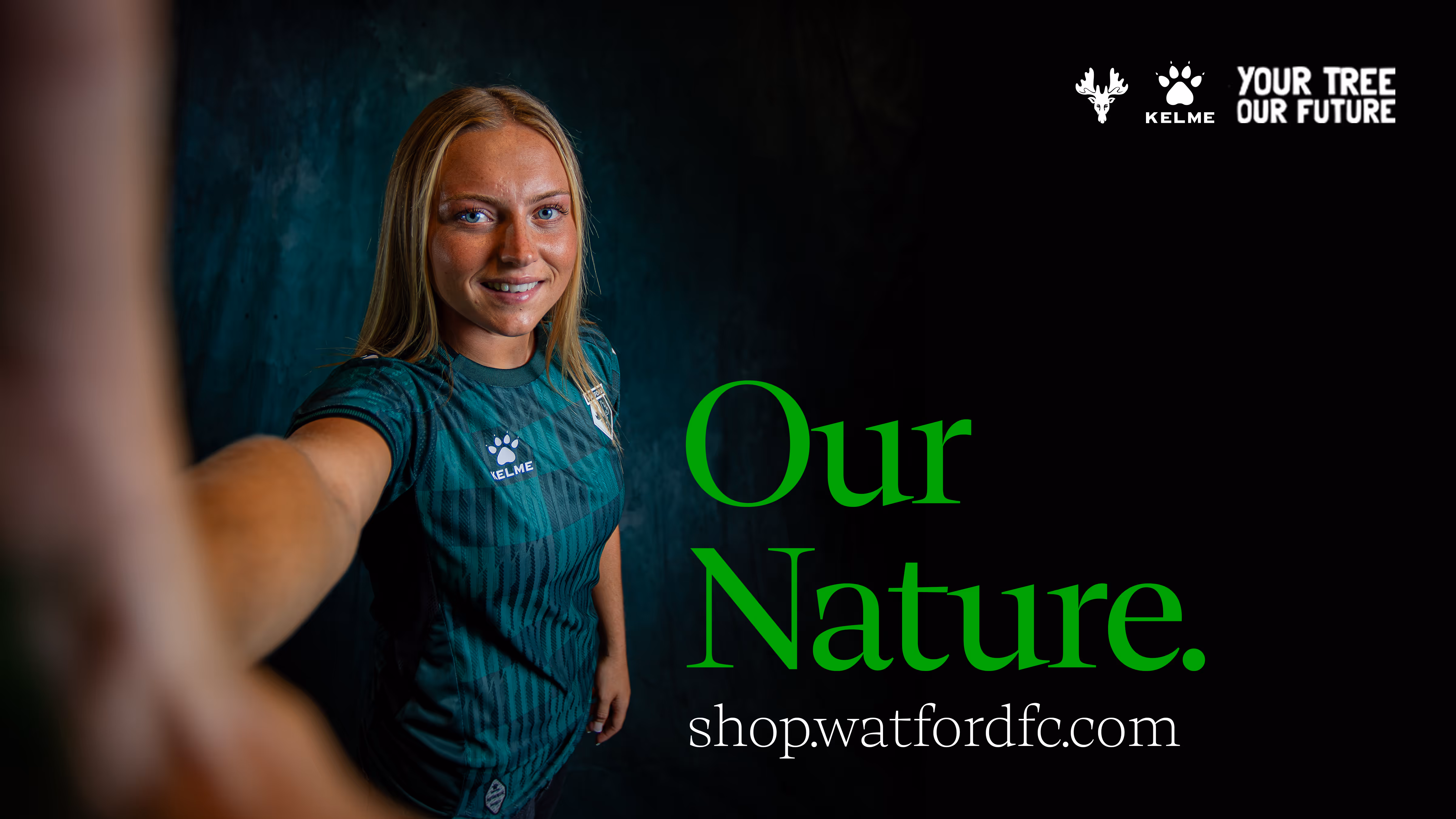 Football player, Maddie Perry, in green Watford FC kit smiling and reaching toward the camera with text 'Our Nature.' and shop.watfordfc.com on black background.