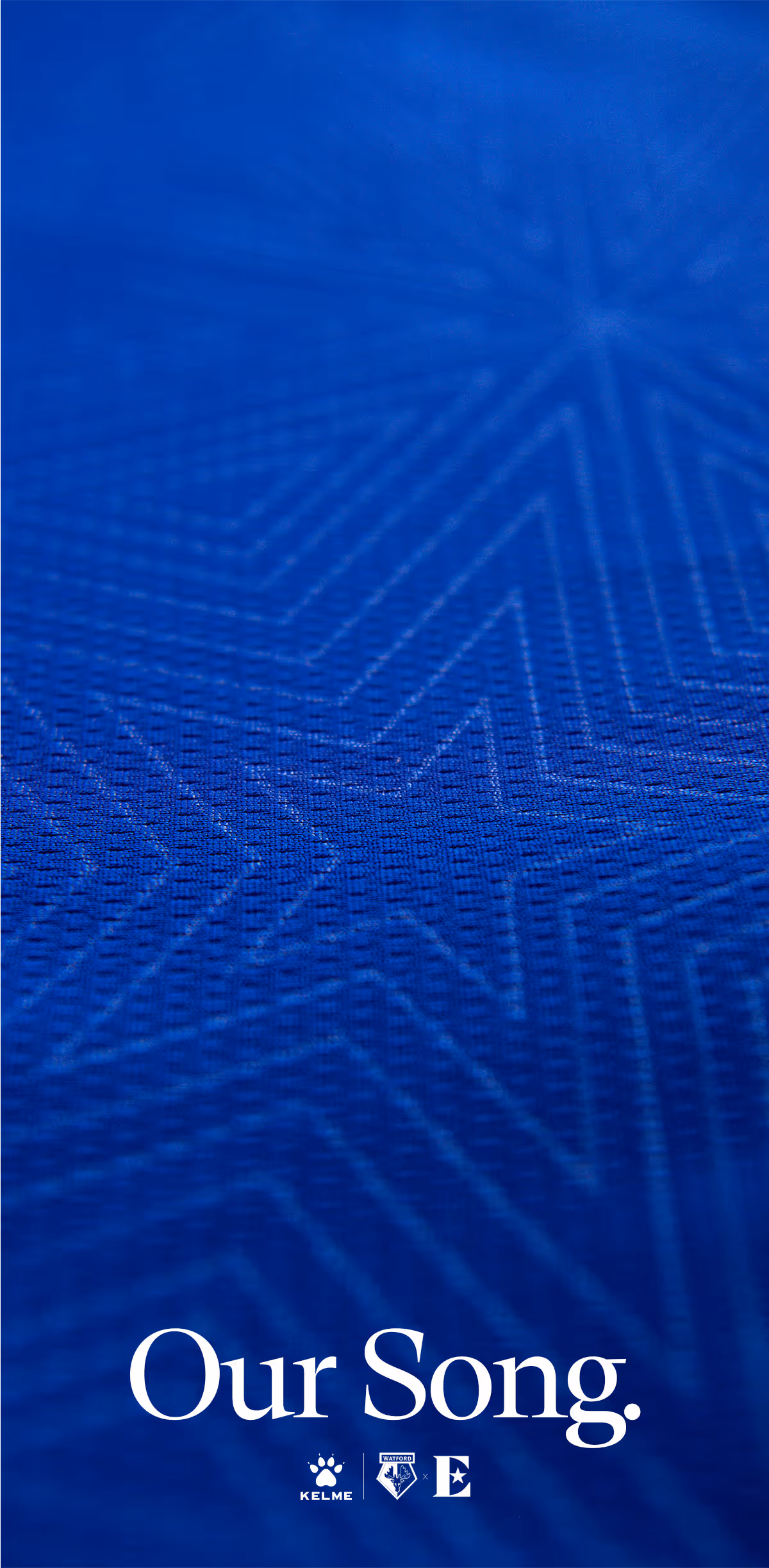 Blue textured fabric with faint star pattern and text 'Our Song.' above Kelme and Watford logos at the bottom.