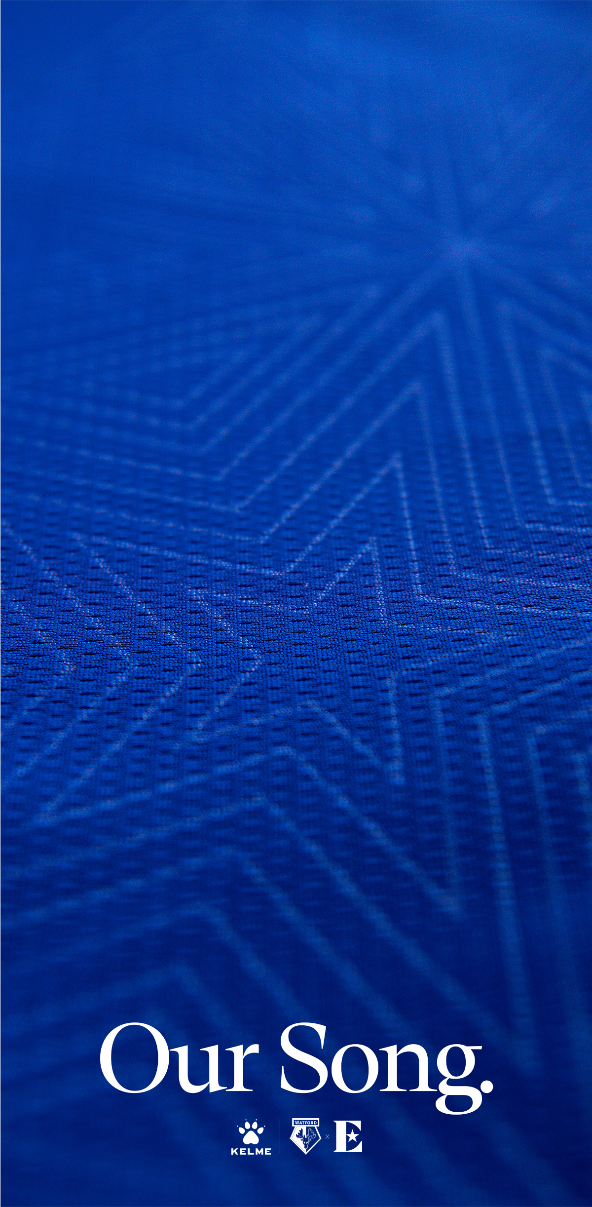 Blue textured fabric with faint star pattern and text 'Our Song.' above Kelme and Watford logos at the bottom.