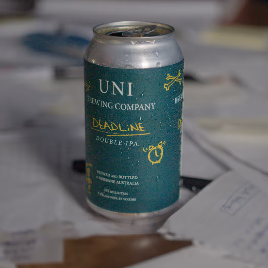 Cold can of Uni Brewing Company's Deadline Double IPA with condensation on its green label.