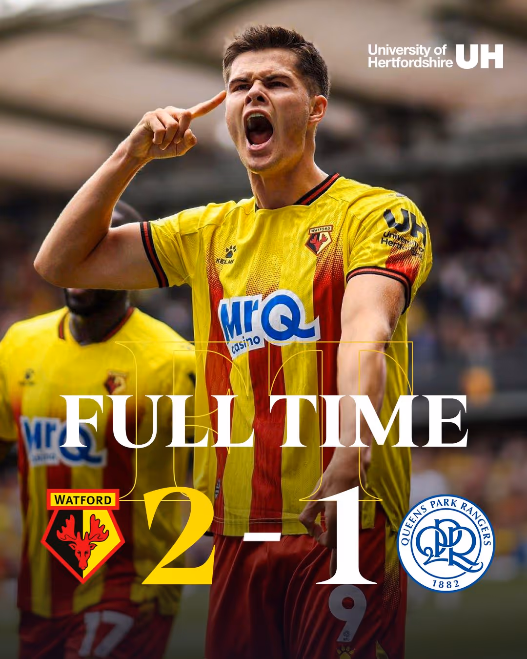 Watford football player, Luca Kjerrumgaard, in yellow and red jersey celebrating with mouth open mid-yell, showing full-time score Watford 2, Queens Park Rangers 1.
