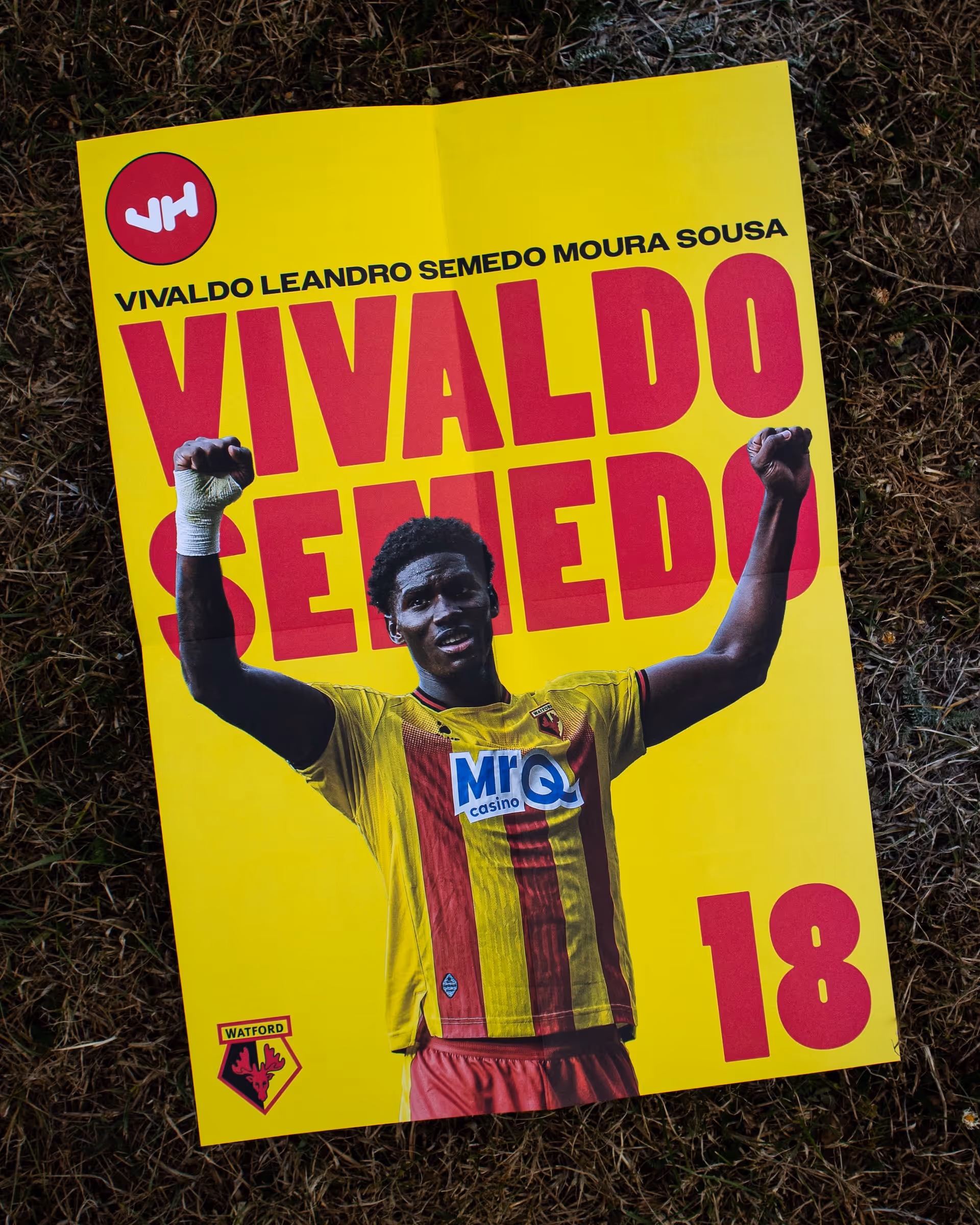 Yellow poster of Watford football player Vivaldo Semedo raising his fists in celebration.