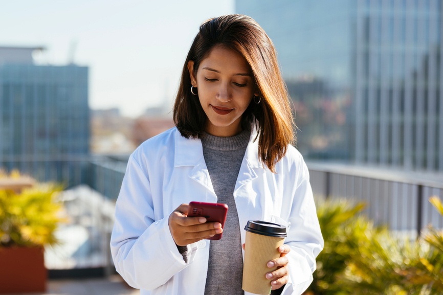 A doctor using Sermo on her phone