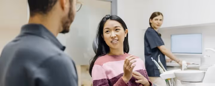 Patient talking to dentist at dental clinic