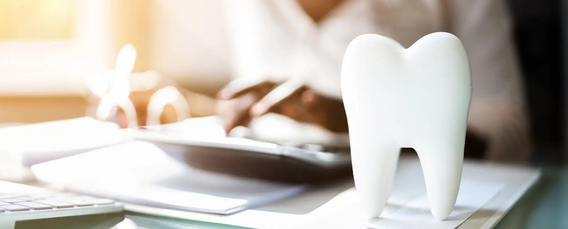 Tooth model on a desk in a dental office.
