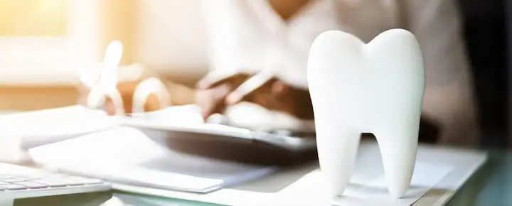 Tooth model on a desk in a dental office.