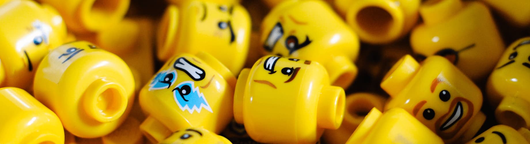 A Bunch Of Yellow Legos With Faces On Them.