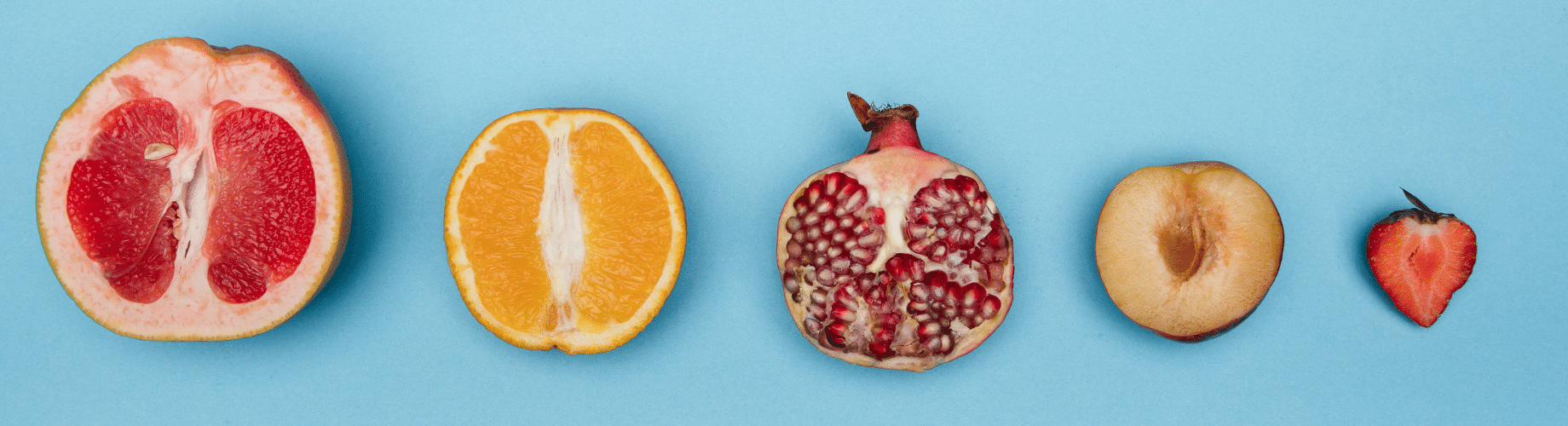 A Group Of Fruit Cut In Half On A Blue Background