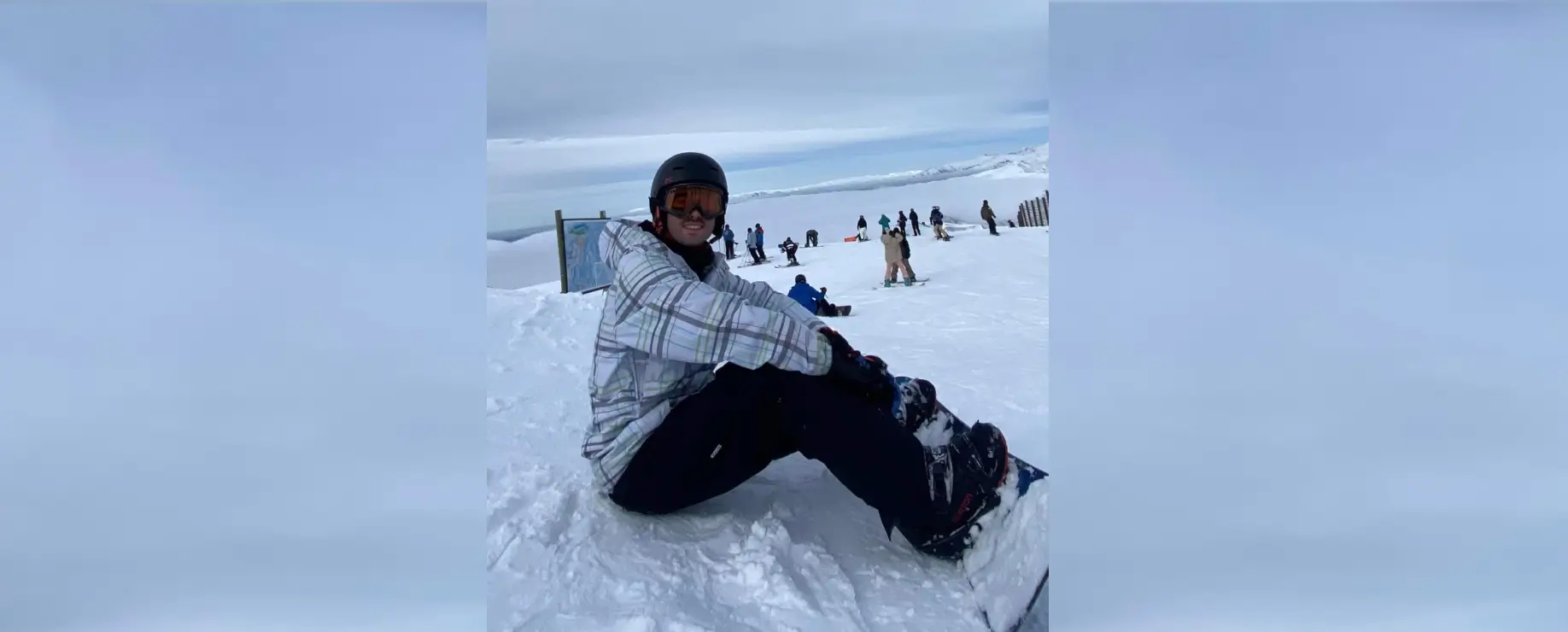 Snowboarder sitting on the snow