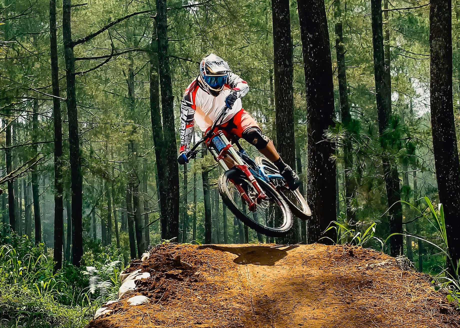 A Man Riding A Dirt Bike On Top Of A Dirt Hill