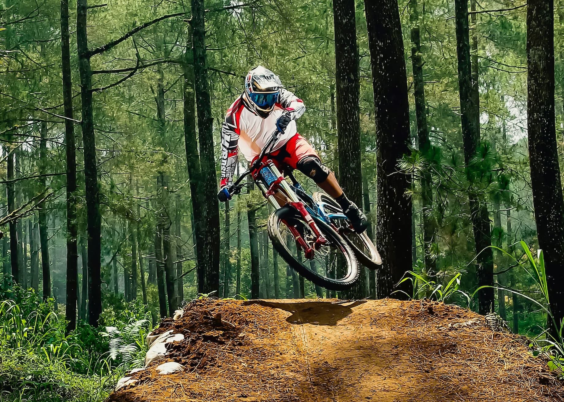 A Man Riding A Dirt Bike On Top Of A Dirt Hill