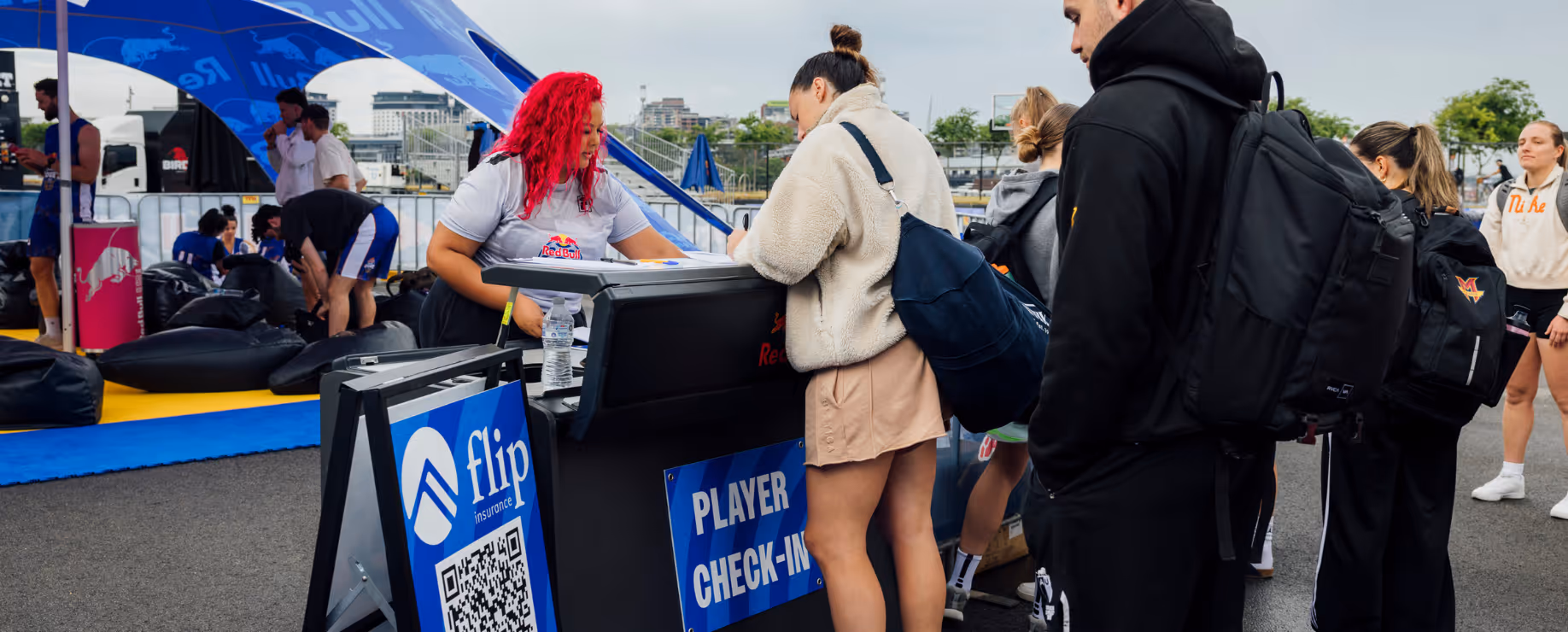 Players checking in at an outdoor sports event registration desk.