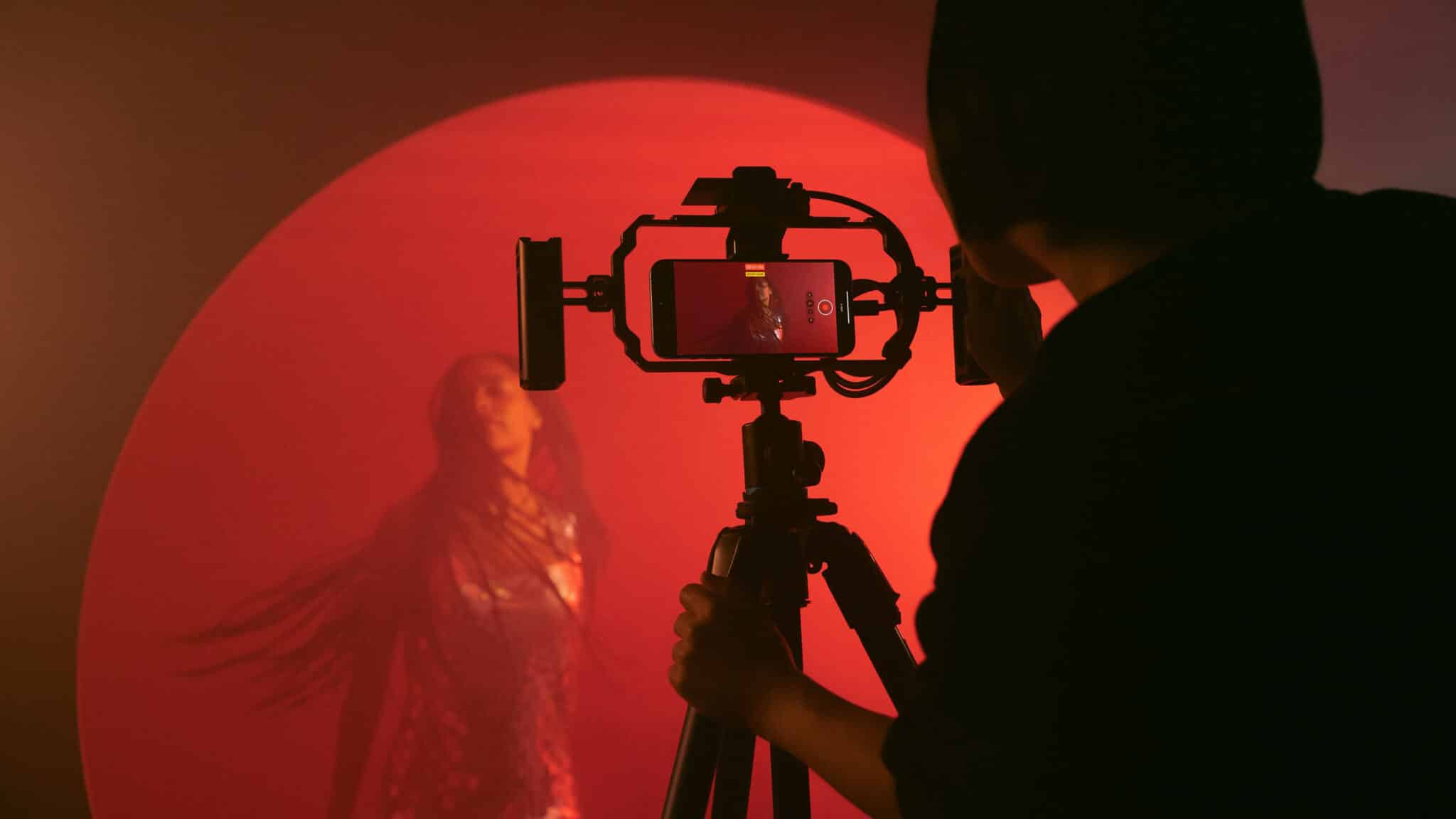 image of video content creator shooting in a restaurant with a smartphone