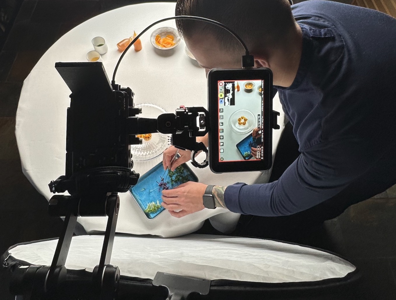 image of video content creator shooting in a restaurant with a smartphone
