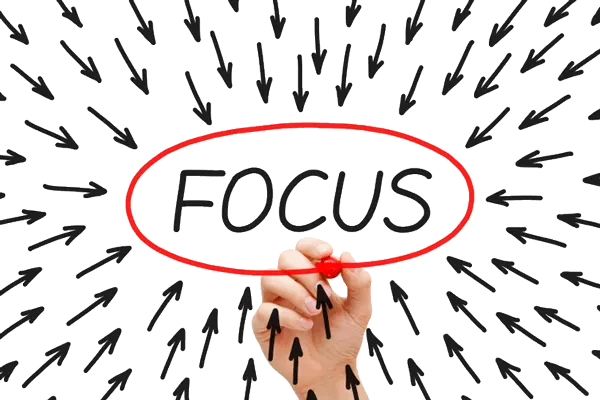 Hand with red marker circling "Focus" with many arrows pointing inward