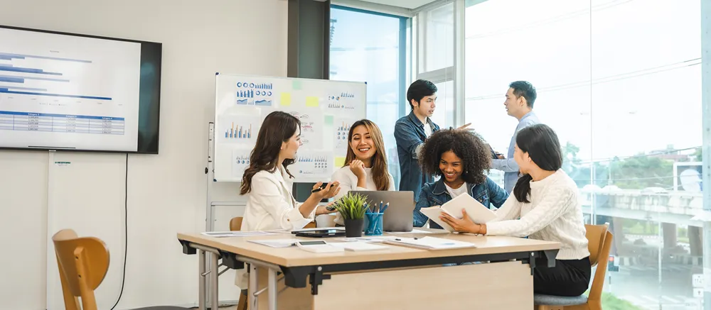 Engaged team of employees celebrating a win — engaged staff drive higher customer satisfaction