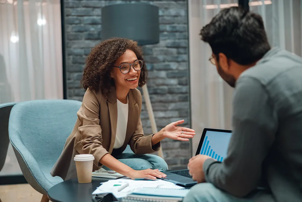 Consultant advising a client on choosing the right monday.com plan during a one-on-one meeting