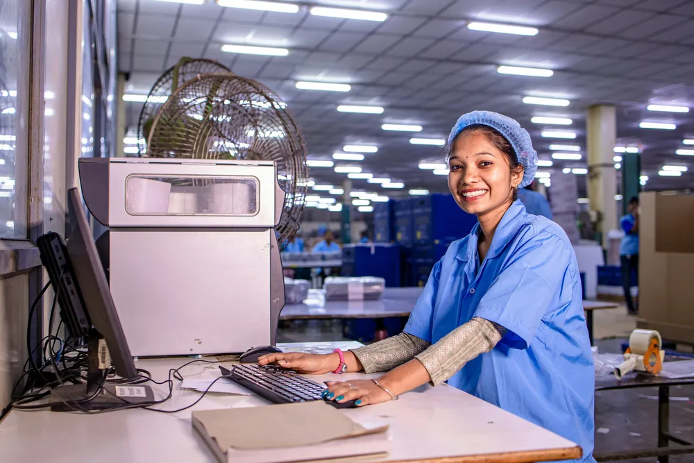Maintenance planner working at a computer on the factory floor