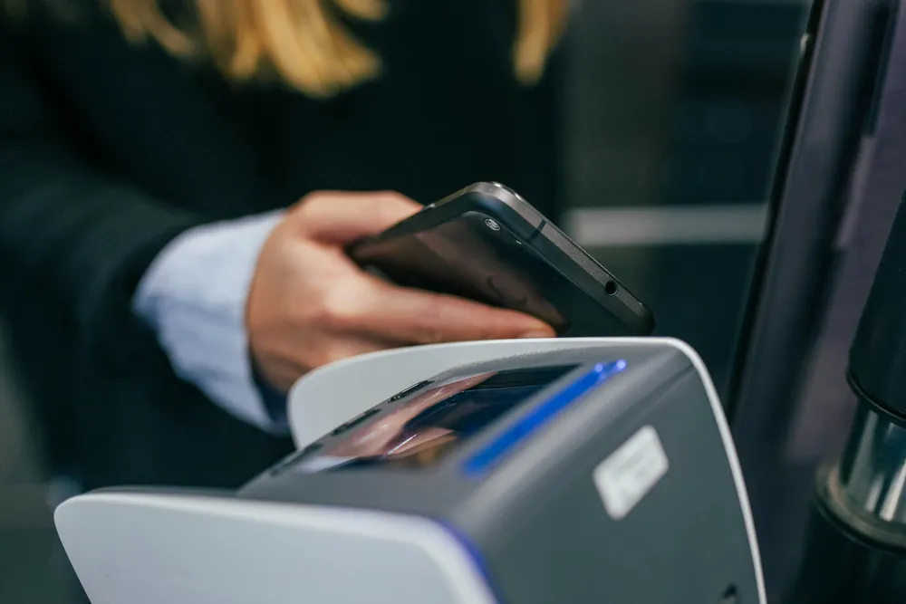 Executive checking a personal smartphone, a route around corporate security controls
