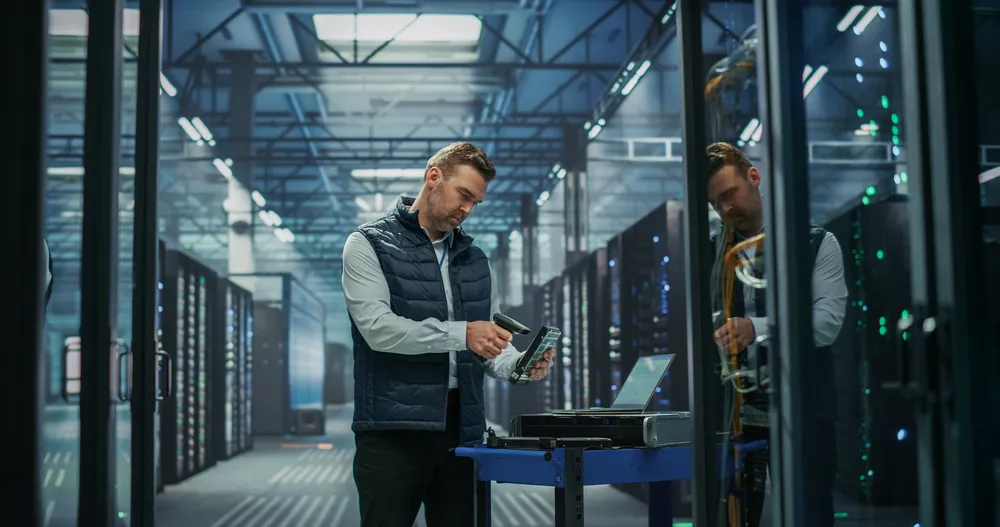 IT technician inventorying server hardware as part of a risk assessment