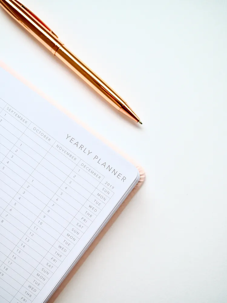 Planner notebook mapping the ten working days of a ClickUp setup