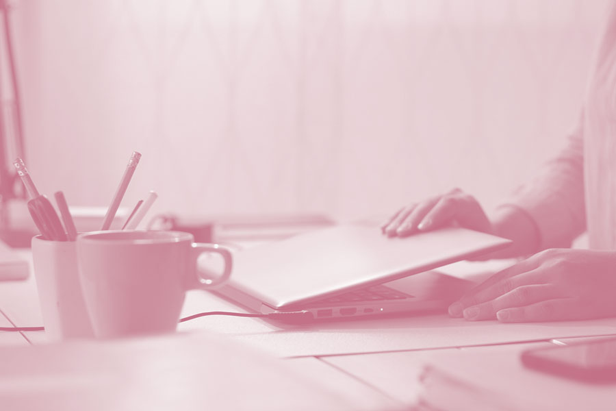 woman closing laptop before leaving the office