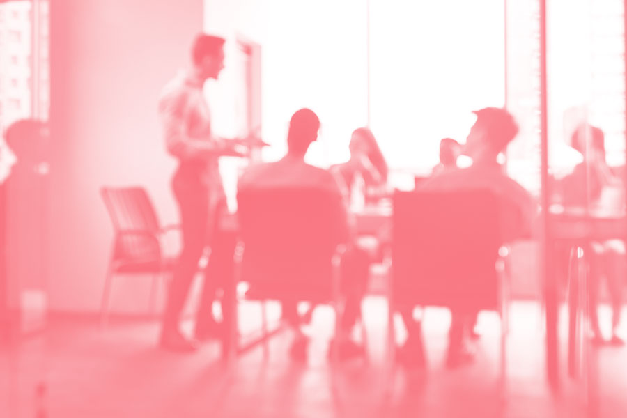 colleagues meet in an office to discuss a tense situation