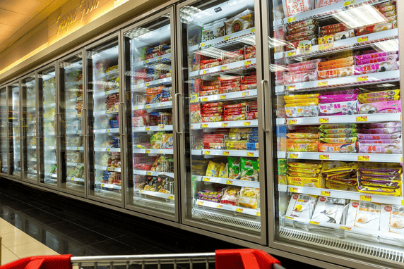 Frozen food aisle at a supermarket, showing freezers full of various products