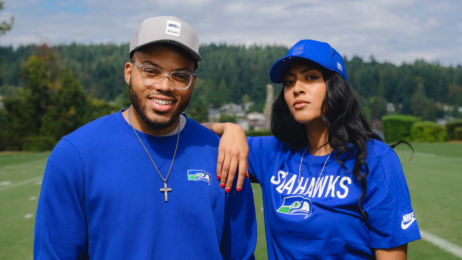 Two fans wearing vintage style Seahawks gear