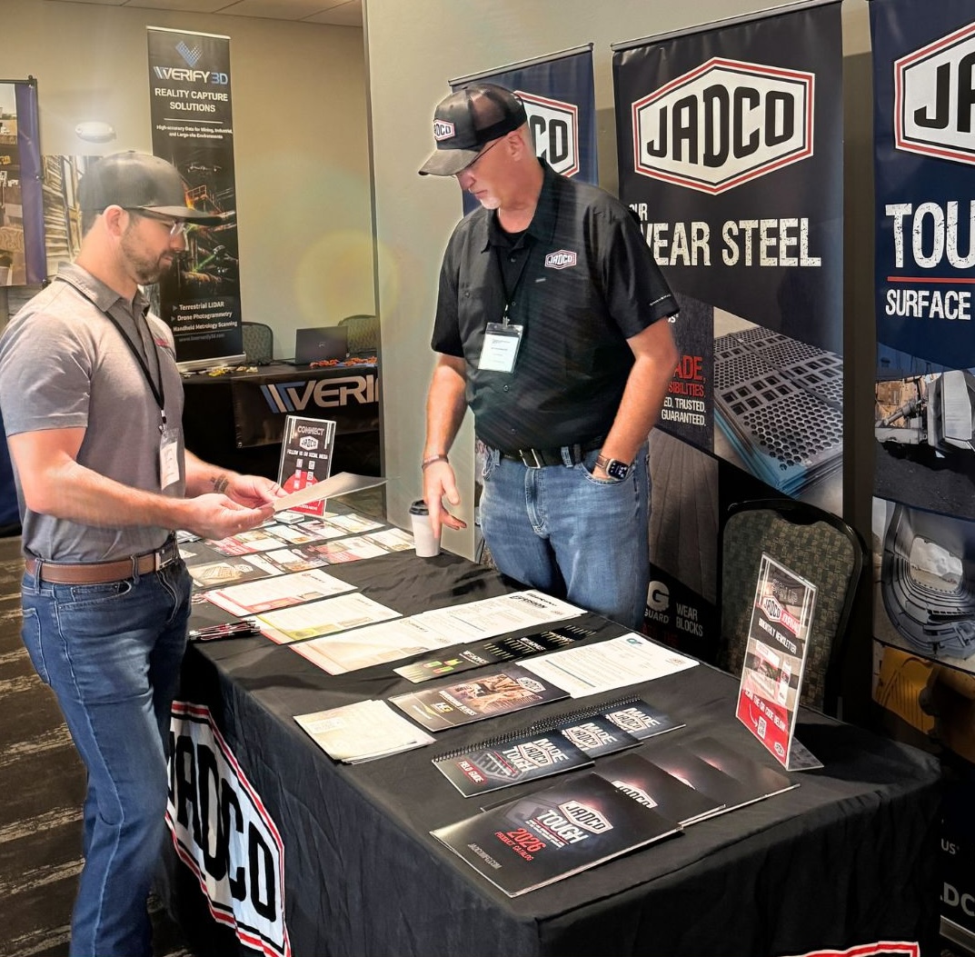 JADCO's team talking with a visitor at their trade show booth