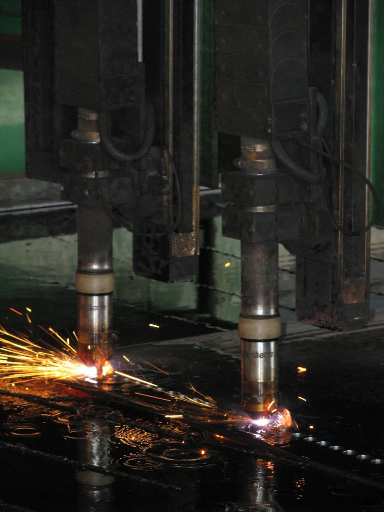 Oxy-fuel torches cutting wear plate on the burn table