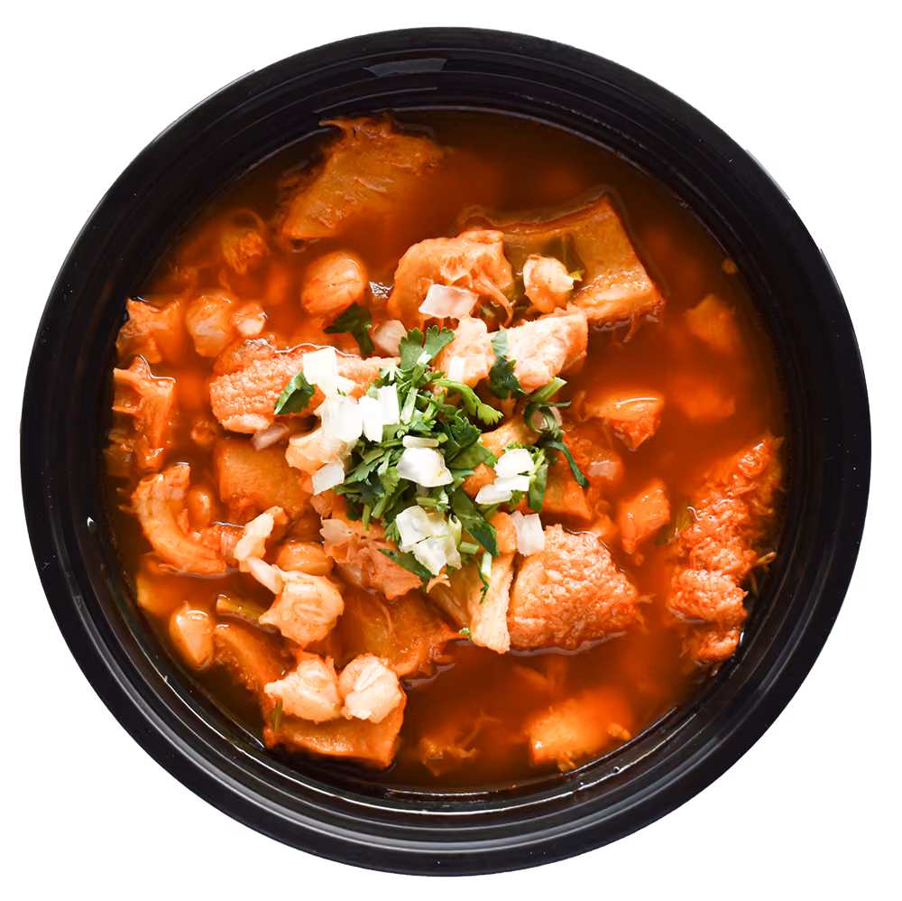 Bowl of meat stew with onion and cilantro topping