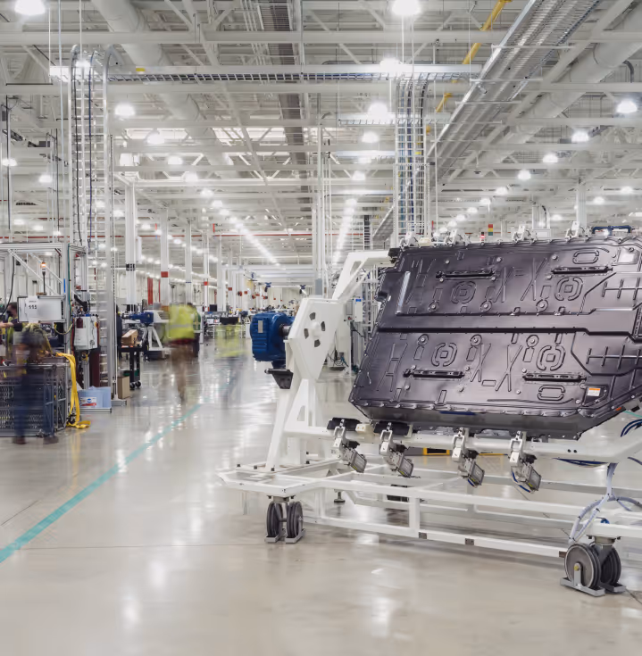 A Rivian battery pack awaits inspection before heading to the chassis line.