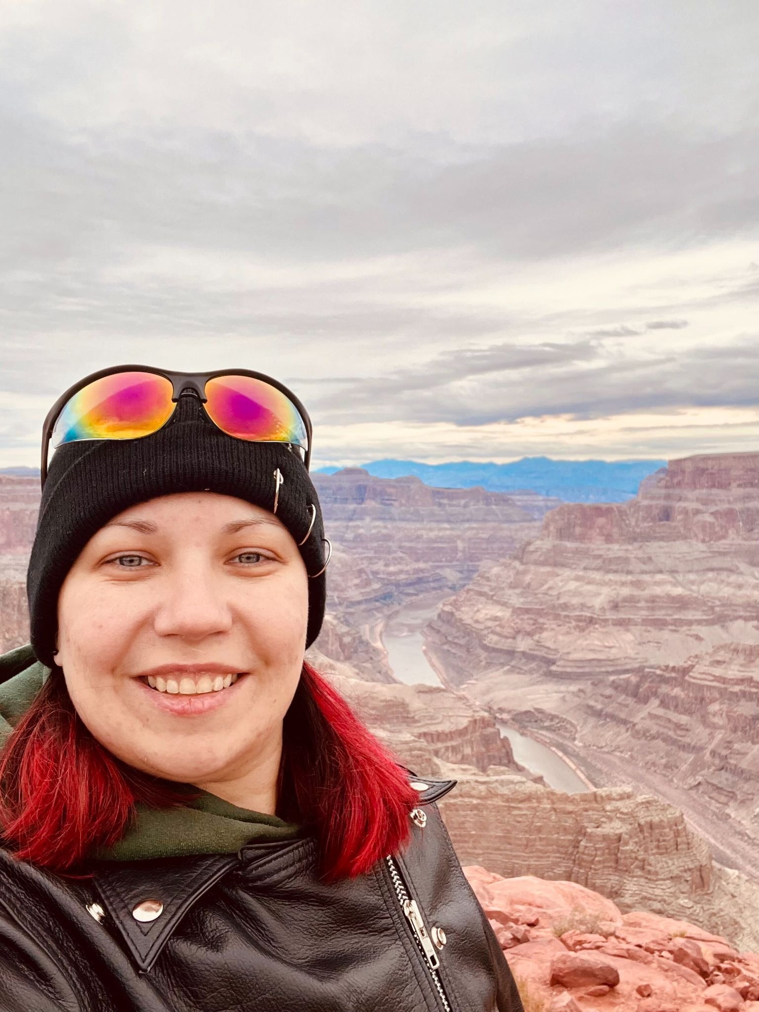 A selfie of Tatiana at the Grand Canyon. Tatiana smiling in the foreground, with a view from the rim of the Grand Canyon.