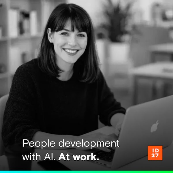 Photo of a young man in an office setting, looking confident and engaged.