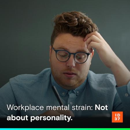 Stressed man sitting in front of a screen, resting his head in his hand and looking exhausted or overwhelmed